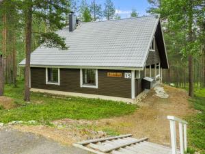 a small house in the middle of a forest at Holiday Home Kevinlevi by Interhome in Sirkka