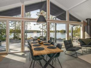 a dining room with a wooden table and chairs at Holiday Home Aurinkoranta by Interhome in Padasjoki