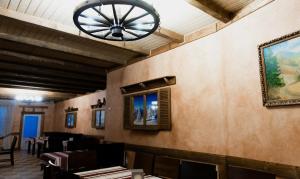 a dining room with a chandelier on the wall at Шепіт Карпат in Pilipets