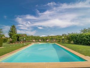 a swimming pool in a yard with a blue at Villa La Quercia by Interhome in Vasanello