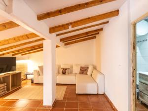 a living room with a white couch and a tv at Holiday Home Robin by Interhome in Sa Pobla