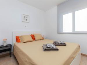 a bedroom with a bed with two towels on it at Apartment Sa Guilla by Interhome in Pals