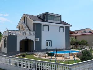a house with a pool in front of it at Holiday Home Golic - KBG302 by Interhome in Karlobag