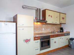 a kitchen with a white refrigerator and a stove at Holiday Home Golic - KBG302 by Interhome in Karlobag
