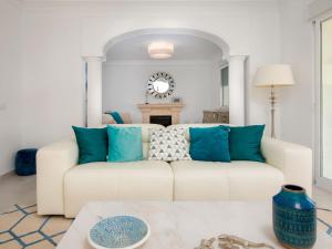 a living room with a white couch and blue pillows at Villa Villa Ewa by Interhome in Jávea