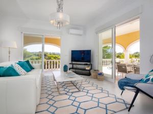 a living room with a white couch and a tv at Villa Villa Ewa by Interhome in Jávea