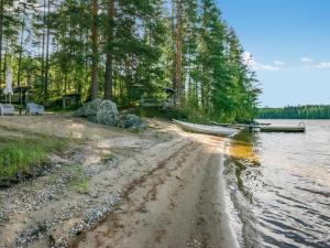 un barco está estacionado en la orilla de un lago en Holiday Home Mäntyranta by Interhome, en Savonranta