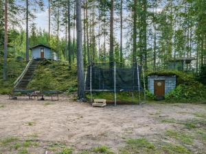 a camping area with a tent in the woods at Holiday Home Mäntyranta by Interhome in Savonranta