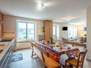 a kitchen and living room with a table and chairs at Holiday Home Les palmiers by Interhome in Saint-Philibert