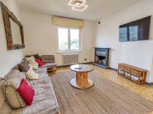 a living room with a couch and a table at Holiday Home Villa Canonica by Interhome in Perledo