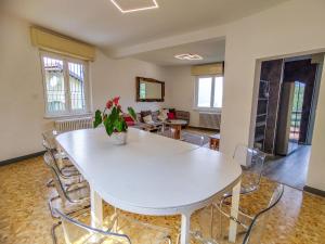 a living room with a white table and chairs at Holiday Home Villa Canonica by Interhome in Perledo