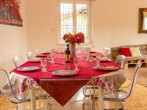 a dining room table with a red table cloth at Holiday Home Villa Canonica by Interhome in Perledo