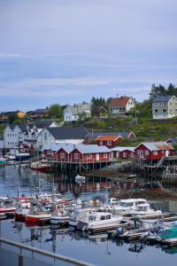 a group of boats are docked in a harbor at The Tide - Hotel in Sørvågen