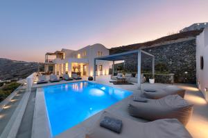 a villa with a swimming pool and a patio at Eolia Luxury Villas in Pyrgos