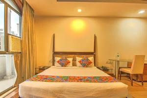 a bedroom with a large bed and a table at Via Le Grand in New Delhi