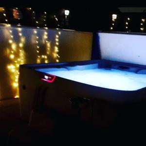 a hot tub with lights in a room at The Blue Horse Suite at The Grumpy Schnauzer B&B Private Hot Tub, Gym, Breakfast, Stunning! in Airdrie