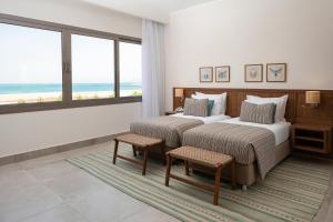 A bed or beds in a room at Steigenberger Resort Ras Soma
