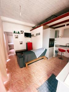a bedroom with a couch and a table in a room at Maison Confortable à Saint Paul avec Vue sur la Mer in Saint-Paul