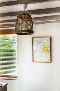 a lamp hanging from a ceiling with a map on the wall at GITE DE L'ORME in Sancerre