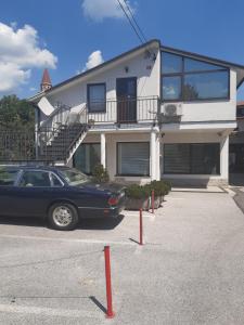 a car parked in a parking lot in front of a house at Istriana boutique apartment in Nova Gorica