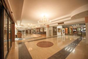 a large lobby with a chandelier in a building at Jolly Alon Hotel in Chişinău