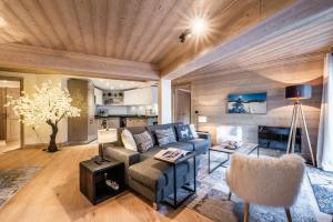 a living room with a couch and a table at Apartment Padouk Moriond Courchevel - by EMERALD STAY in Courchevel
