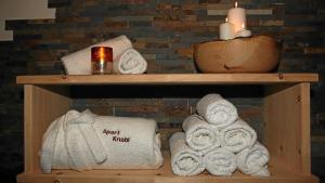 two wooden shelves with towels and candles on them at Apart Knabl in Sankt Leonhard im Pitztal +35 photos
