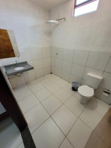 a bathroom with a toilet and a sink at Hotel Buriti in Carolina
