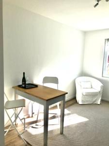 stół i krzesła w pokoju z białą kanapą w obiekcie Un sejour a Cabourg w mieście Cabourg