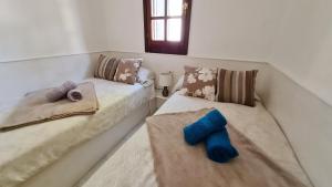 Łóżko lub łóżka w pokoju w obiekcie Casa EL JARDIN