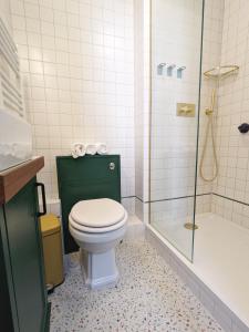 a bathroom with a toilet and a shower at The Stirling Arms Pub & Rooms in Brighton & Hove