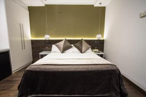 a bedroom with a large bed with two pillows at Moderno in Barcelona