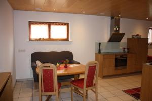 a kitchen and dining room with a table and chairs at Apartment mit Sauna in Frickingen