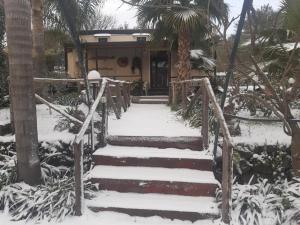 a snow covered staircase in front of a house at B&B Etna Ranch in Piedimonte Etneo