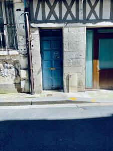 two blue doors on the side of a building at Escapade romantique - Jacuzzi et Parking privé - 002 in Rouen