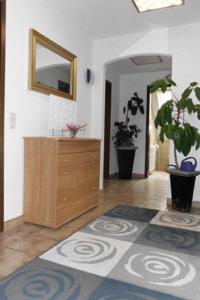 a living room with a dresser and a mirror at Ferienwohnungen Federleicht in Wermelskirchen