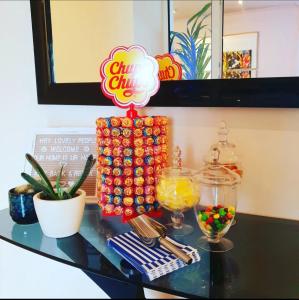 a glass table with a candy bar on top of it at The Green Monkey Lux Suite at The Grumpy Schnauzer B&B Private Hot Tub, Gym, Breakfast, Stunning! in New Monkland