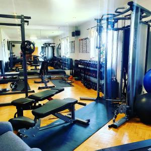 a gym with a bunch of equipment in a room at The Green Monkey Lux Suite at The Grumpy Schnauzer B&B Private Hot Tub, Gym, Breakfast, Stunning! in New Monkland