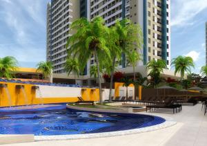 a resort with palm trees and a swimming pool at SOLAR DAS AGUAS PARQUE RESORT in Olímpia