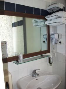 a bathroom with a sink and a mirror at Hotel Bellevue in Brest