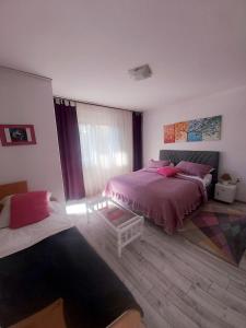 a bedroom with two beds and a window at Apartment Sim in Banja Luka