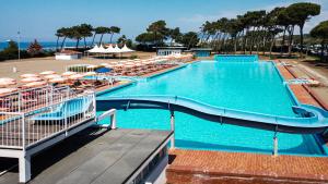 a large swimming pool with a slide in a resort at Villaggio Torre Marina in Marina di Massa