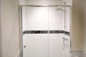 a shower with a glass door in a bathroom at George and Dragon in Horsham +8 photos