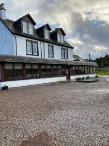 a large white house with a lot of windows at West Loch House in West Tarbert