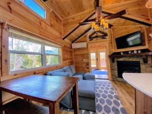 B2 NEW Awesome Tiny Home with AC Mountain Views Minutes to Skiing Hiking Attractions في Carroll: غرفة معيشة مع أريكة وتلفزيون ومدفأة