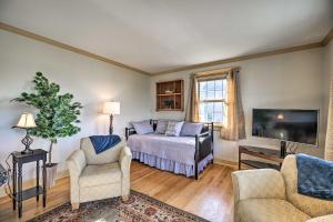 a living room with a bed and a tv at Waterfront Lake Champlain Home with Fire Pit! in Saint Albans Bay