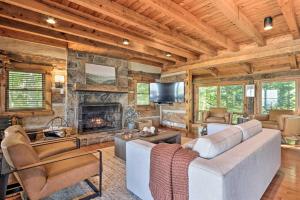a living room with a couch and a fireplace at Upscale Gatlinburg Cabin Deck, Fire Pit and Hot Tub in Gatlinburg