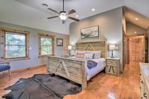 a bedroom with a bed and a ceiling fan at Upscale Gatlinburg Cabin Deck, Fire Pit and Hot Tub in Gatlinburg