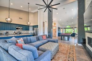 a living room with a blue couch and a fireplace at Putting Green Golfers Getaway in Scottsdale in Scottsdale