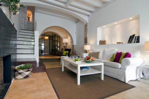 a living room with a white couch and a table at La Casita del Mar in Sitges
